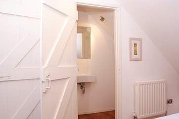 The upstairs bedroom has an en suite WC.