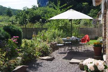 French windows from the living-area and the ground floor bedroom open onto the gravelled patio-area.