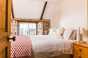 The master bedroom has views across the courtyard (Bedroom 1).