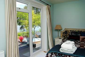 Bedroom 3 has a door to the deck and river views.