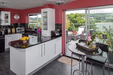 Patio doors from the kitchen go out to the balcony.
