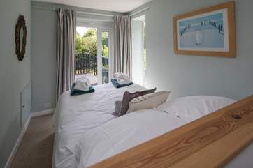 Bedroom one on the first floor is super cute and leads out onto it's very own patio area.