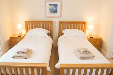 The twin bedroom is on the ground floor and is neutral and calm and has ample storage.