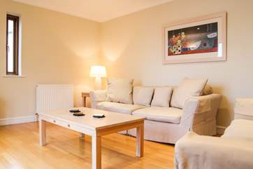 The sitting-room on the first floor has comfy sofas to relax on.