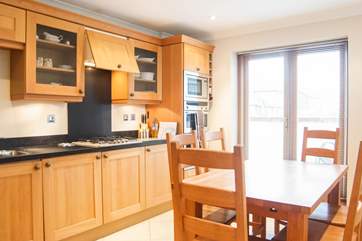 The kitchen/dining-room has doors out to the balcony.