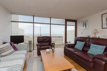 The open plan living space has floor to ceiling glass and a door to the open fronted patio - great for people watching and of course sea views.