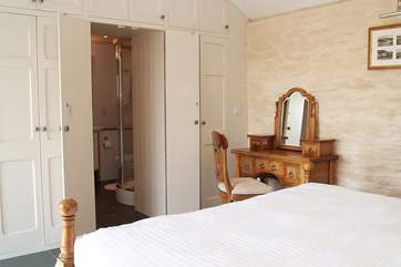 The beautifully crafted wardrobe hides the gorgeous bathroom.