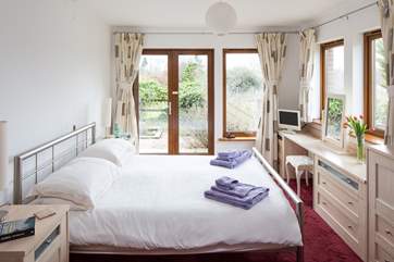 The master en-suite bedroom has French doors leading out onto the rear terrrace.