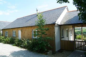 The view of the cottage from the drive. The covered deck leads to the garden at the rear.