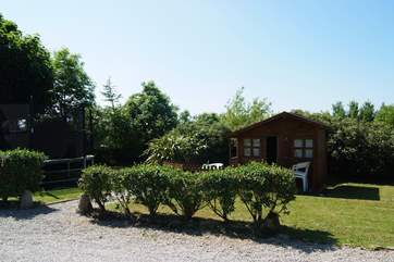 The shared play-area includes a summer-house and a children's trampoline.