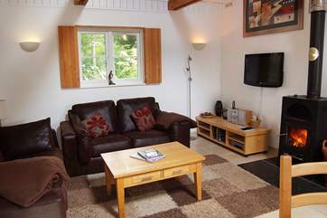 The sofas in the sitting-area surround the cosy wood-burner.