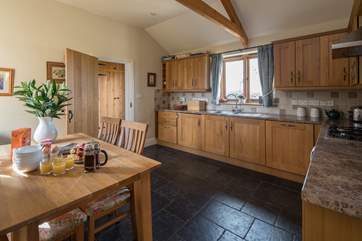 The spacious and well-equipped kitchen is connected to the bathroom and bedrooms by a delightful entrance hall.