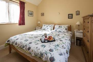 The comfortable master double bedroom with en suite shower-room.