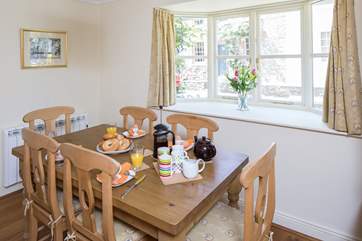 The dining area has a large bay window.