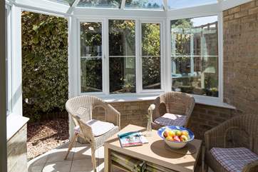 The pretty conservatory is a great place to relax with morning coffee or an evening glass of wine.