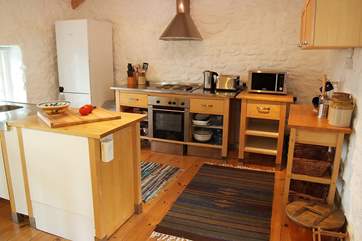 The stylish birchwood and stainless steel kitchen-area.