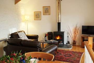 Leather sofas surround the welcoming wood-burner in the sitting-area.