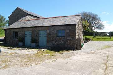 The entrance to the cottage parking with the laundry-room for Little Trebarvah in the single-storey barn on the left.