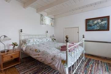 The master bedroom with pretty bedding linking to the outside (Bedroom 1.)