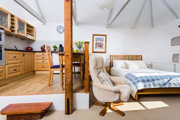 There are two comfy chairs and a footstool when you want to relax after dinner.