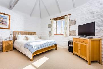 Lounge in bed, enjoying the light space with high ceilings or snuggle up and watch TV.