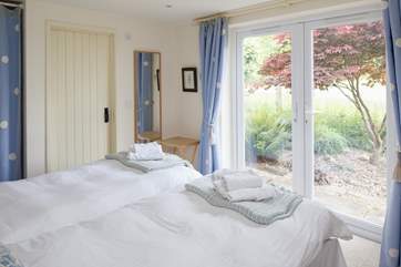 French doors from the ground floor bedroom open onto the garden with views across the fields (Bedroom 1).