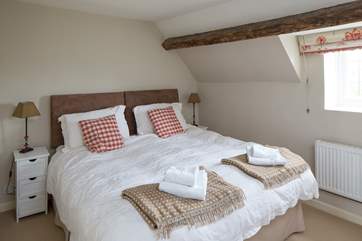 Bedroom 2 on the first floor has exposed beams, lovely throws and an en suite shower-room.