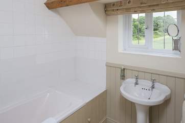 The family bathroom on the first floor has fabulous views across the surrounding fields.