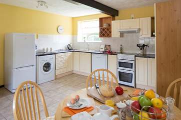 The bright kitchen with dining-area has plenty of space.
