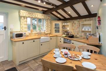 The farmhouse-style kitchen is very well-equipped and feels so welcoming when you step inside.