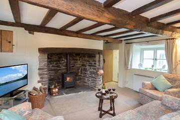 There is a spacious but very cosy living-room with a wonderful inglenook fireplace and wood-burner.