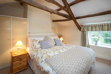 The master bedroom has a super-king size bed and views over the very pretty garden.