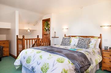 The pretty bedroom has a comfy king size bed
