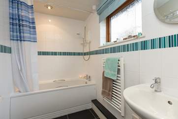 This is the bathroom, offering the option of both a bath and a shower.
