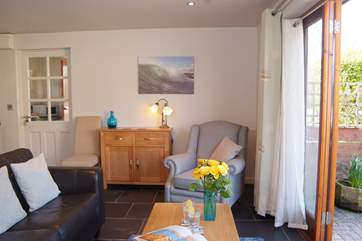 The cottage is very light and welcoming. With the choice of a two seater sofa and comfortable armchair.