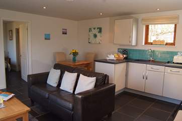 The dining-table is at the back of the room but of course you can eat outside in the sunshine too.