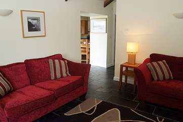 The sitting-room is just off the kitchen/dining-room and bedroom and has two comfy sofas.