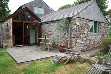 Chynoweth Cottage is a single-level twin stone barn conversion with the kitchen/dining-room on the left and the sitting-room on the right.
