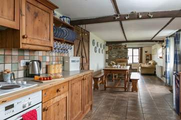 The sociable open plan kitchen and dining areas lead through to the sitting-area.