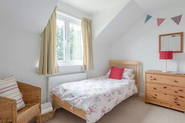 Bedroom 4 looks out over the lawns and grounds at the back of the cottage.