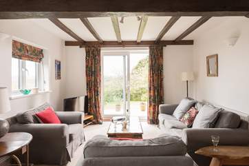 The big sitting-room looks out over lawns and undulating countryside.