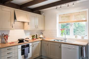 The Shaker-style kitchen is very well-equipped.