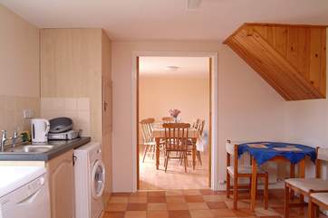 The kitchen leads to the dining-room.