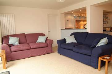 Large comfortable sofas overlook the garden and patio areas.