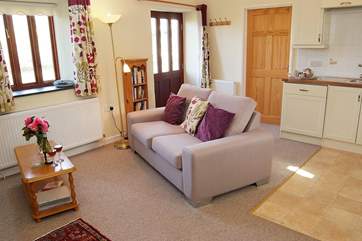 The open plan living-room leads into the double bedroom.