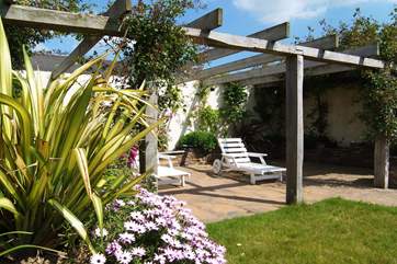 The pretty patio-area complete with sun-loungers.