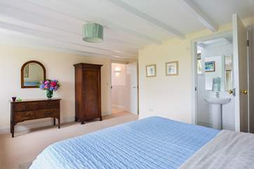 The spacious en suite master bedroom is along the hall from the other rooms on the lower ground floor.