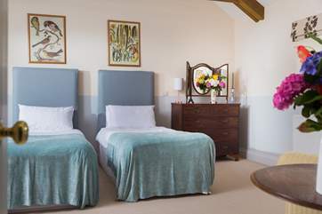 Spacious Bedroom 3 is furnished with versatile 'zip and link' (double or twin) beds, and has a door leading out to the garden.