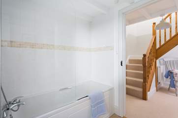 The family bathroom on the lower ground floor is between Bedrooms 2 and 3 at the bottom of the stairs.