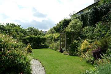 The lawn-area in front of the summer-house where you can relax or play games.